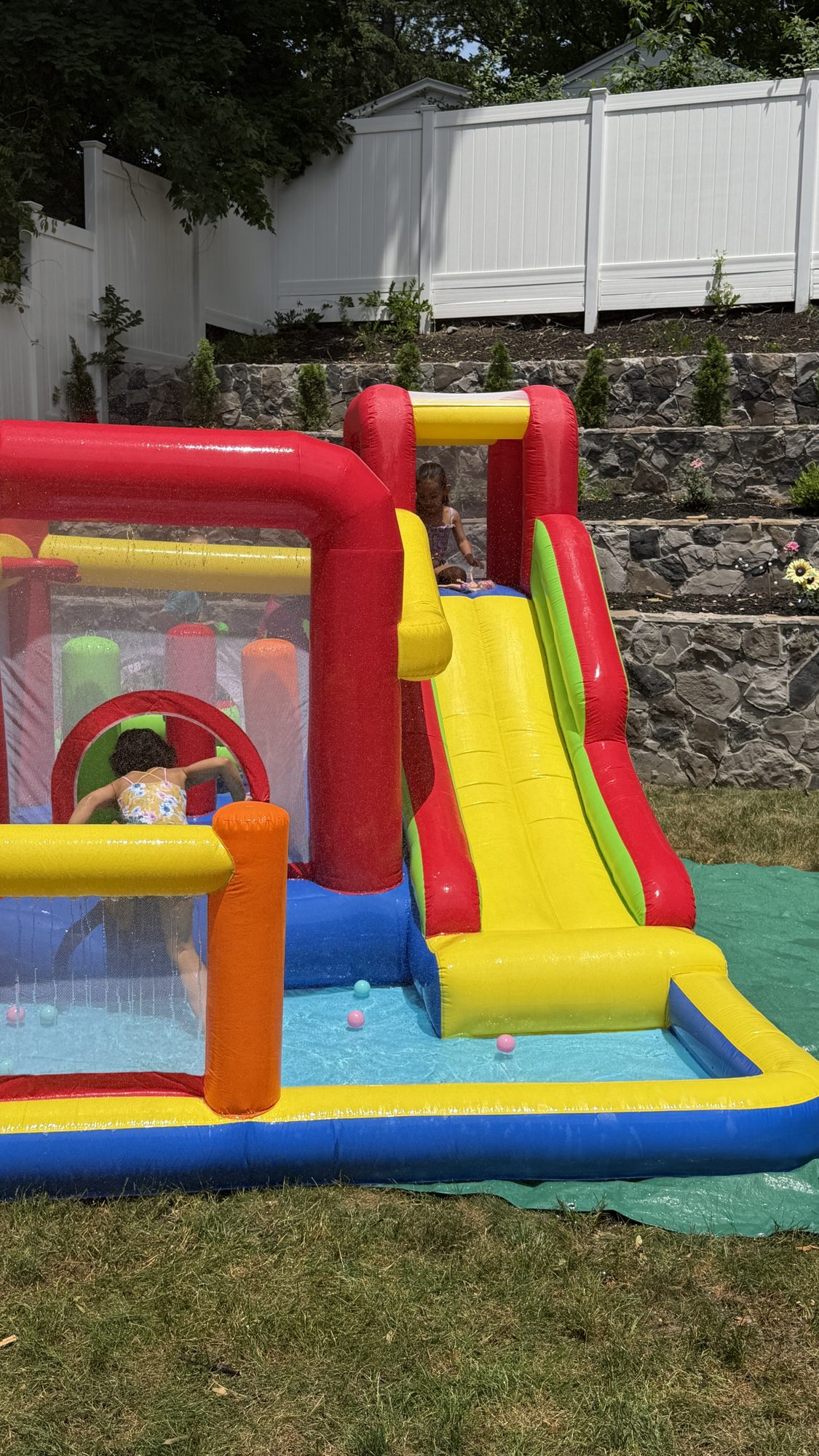 The Play Haus in wet setup, water running down the slide into the splash pool at its base
